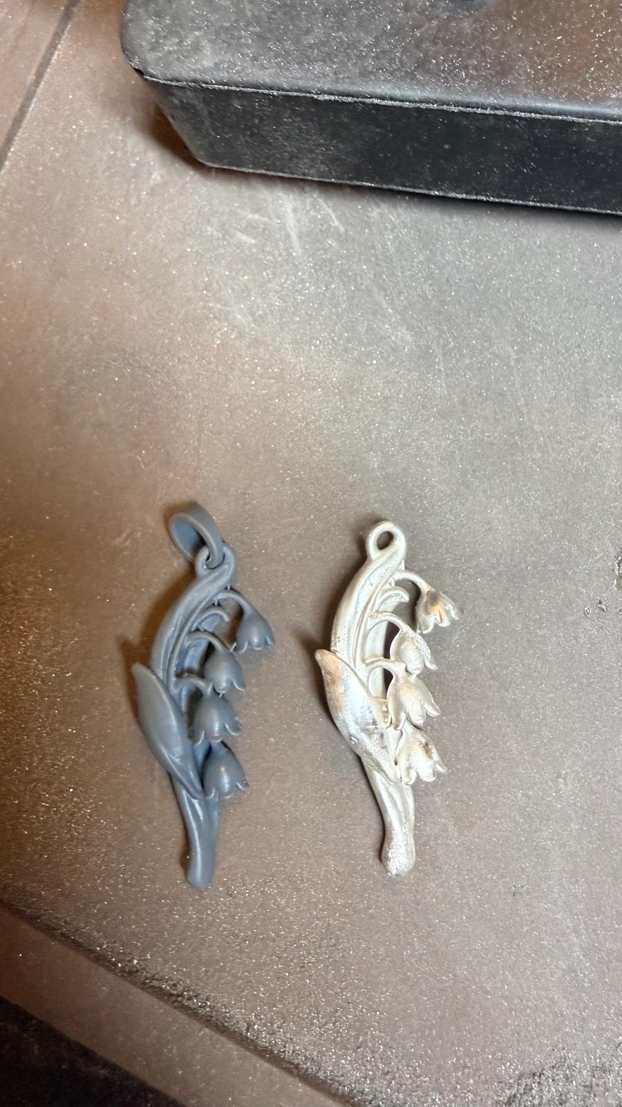 Lily of the Valley resin model on the left and metal version on the right, photographed together on the workbench