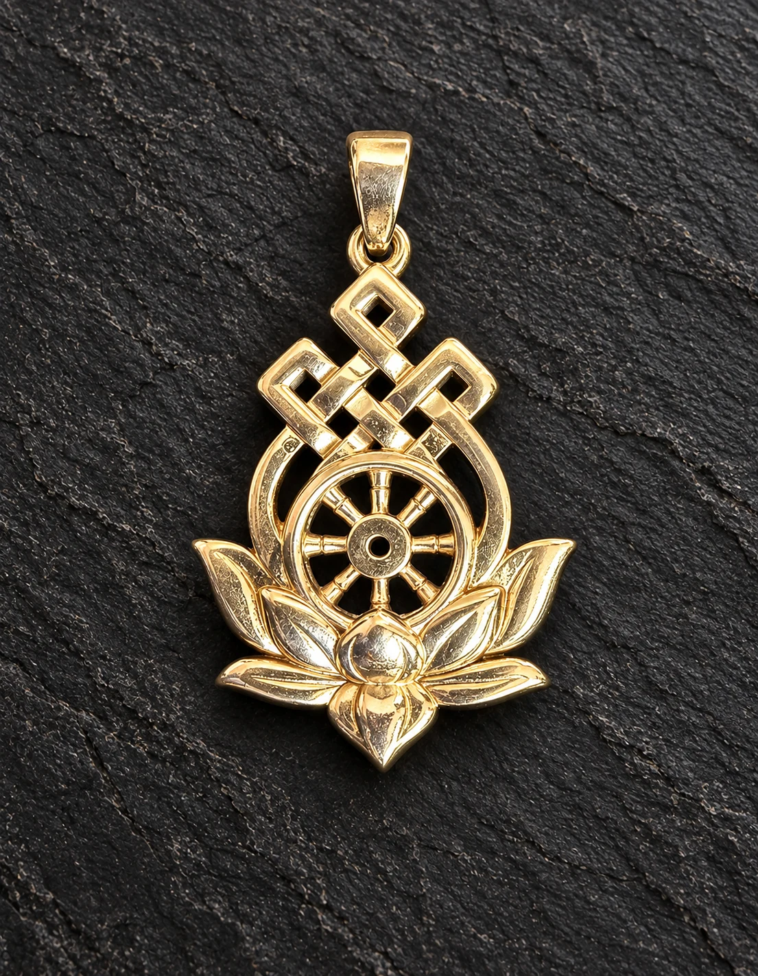 Gold Buddhist pendant combining a lotus, Dharma wheel and endless knot, on charcoal stone