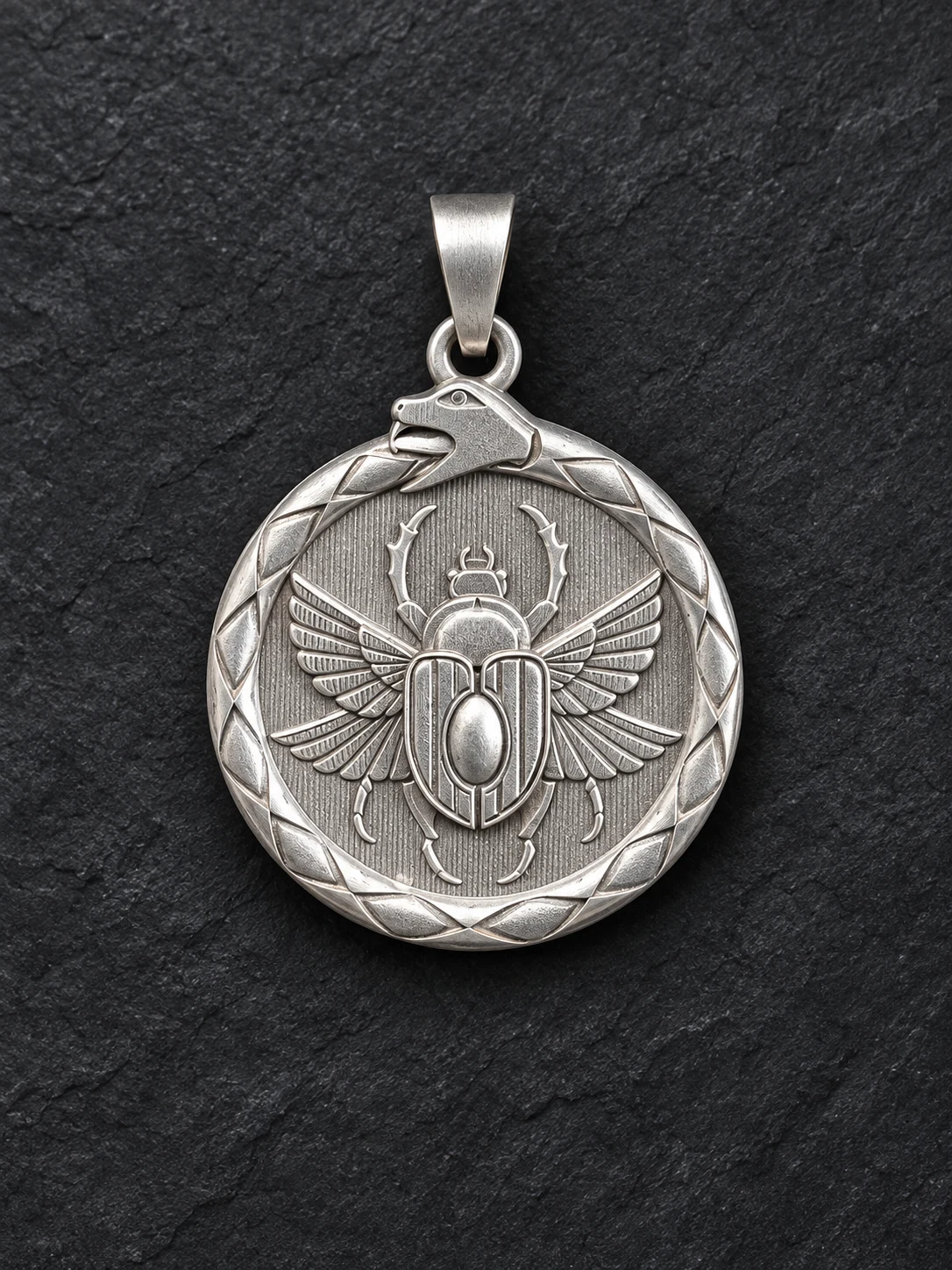 Sterling silver pendant with a winged scarab framed by an Ouroboros